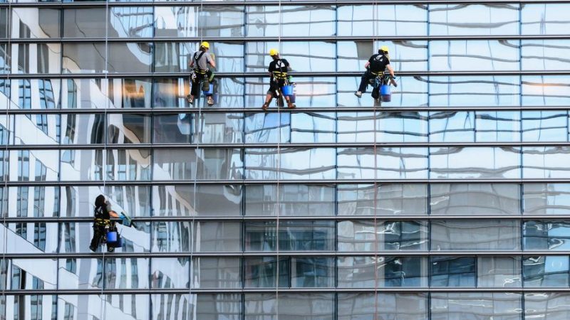 professional window washers cleaning high-rise building