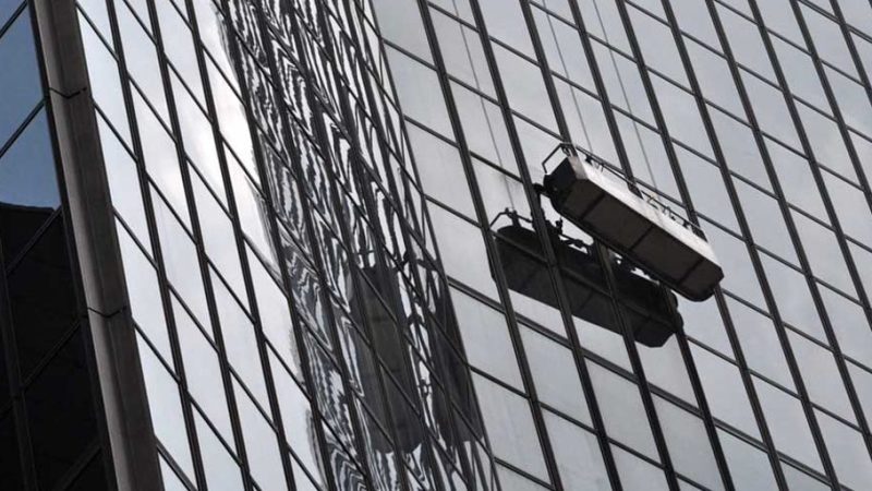 professional window washers cleaning high-rise building